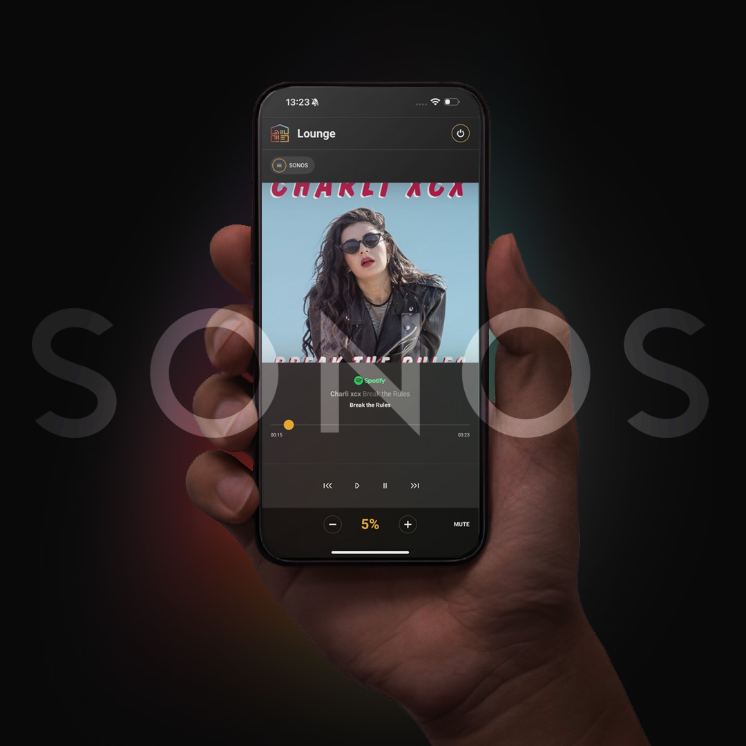 Hand holding iPhone and using uControl with Sonos integration